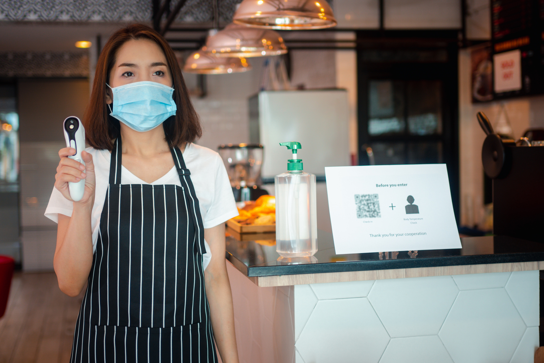 Asian  woman wearing face masks and holding an infra
